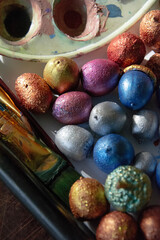 close up of colorful acorns on a white background and brushes