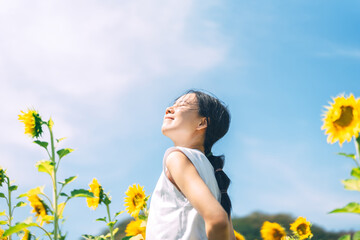 Solitude and freedom woman standing relax in sunflower botanical field park outdoors with sunlight