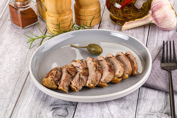 Roasted duck breast slices in the plate