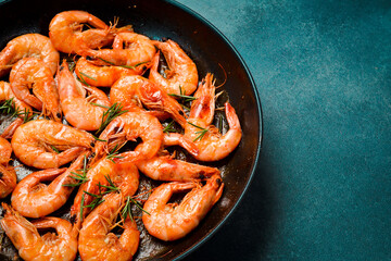 Pan with fried shrimps. Side view. Close-up. Cooking background.