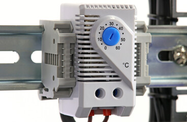 An electric thermostat for temperature control in an electric switchboard.