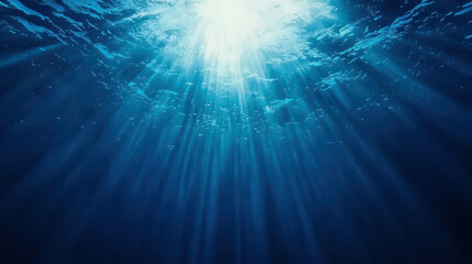 Fototapeta premium Small Bubbles Rising Through Deep Blue Water in Underwater Light Rays