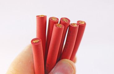 The hand is holding a copper electrical insulated mounting cable. 