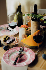 Table with a pink plate and a fork and knife on it