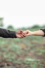 pre-wedding photo of the bride and groom posing holding hands