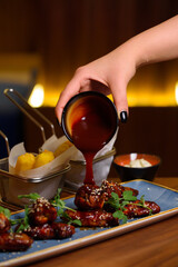 fried chicken wings topped with sauce