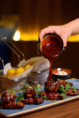 fried chicken wings topped with sauce
