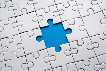 Fototapeta premium Close-Up of Pale Blue Jigsaw Puzzle with Missing Bright Yellow Piece at Center, Featuring Scattered Pattern on Light Gray Background for a Clean, Modern Aesthetic