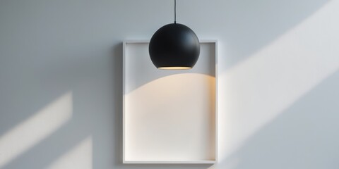 A white wall with a white frame and a black light hanging above it