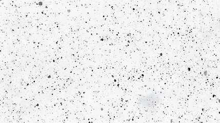 Obraz premium White textured surface with small black specks.