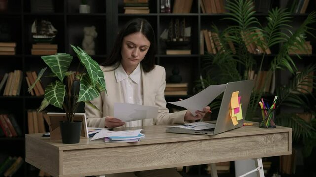 Woman reads contract and makes changes to improve readability
