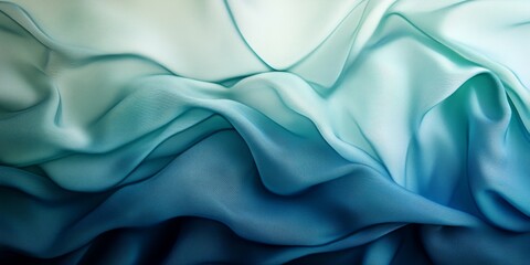 Fototapeta premium Abstract blue and green gradient color cloth textile texture background featuring soft waves. This close up drapery background captures the softness and mood of blue and green tones.