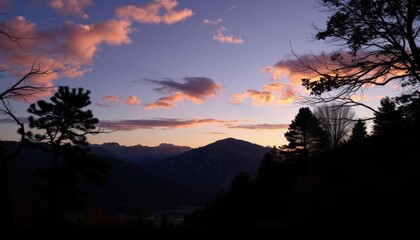 view of a mountain range with a lake and trees
