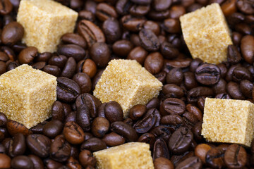 beautiful picture, a background with coffee and sugar, a cube of cane sugar on coffee beans, a close-up of a coffee and sugar
