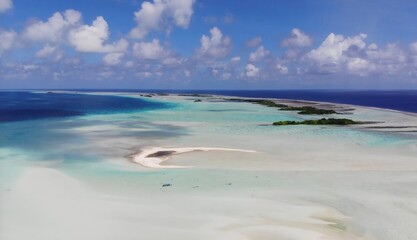 Sand bank acting as a barrier between lagoon and ocean waters, Rangiroa, French Polynesia.