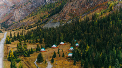 Aerial view captures glamping domes amidst the colorful autumnal landscape of the altai mountains, offering a unique blend of comfort and wilderness © wifesun
