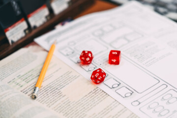 Red dice D20 place on adventure story TTRPG book role playing tabletop game and board games