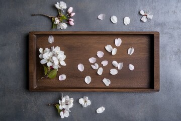 Flat Lay of Sakura Blossoms on Wooden Tray for Elegant Spring Design