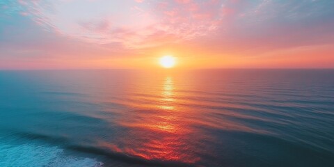Obraz premium Stunning sunset or sunrise sky over the sea creates a beautiful landscape. This vibrant and colorful light of nature enhances the seascape, captured through a drone aerial view of the ocean