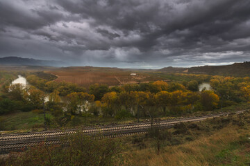 Cñlouds and rain shower over the Ebro river at San Asensio