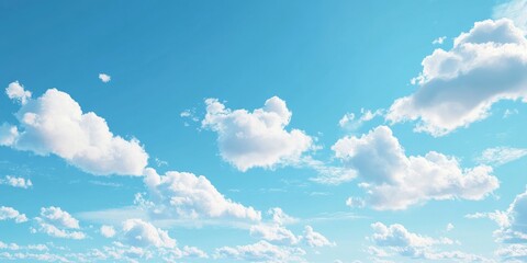 Soft, white clouds of spring float in a bright blue sky during a sunny day. This clear, natural backdrop offers ample space for adding text.
