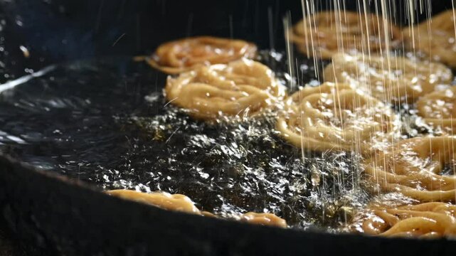 Jalebi making. It is a popular sweet snack in India subcontinent. It is many names&nbsp;jilapi,&nbsp;jilebi,&nbsp;jilipi,&nbsp;zulbia,&nbsp;mushabak,&nbsp;z&rsquo;labia and&nbsp;zalabia. Its made by maida flour&nbsp;batter&nbsp;and sugar syrup.