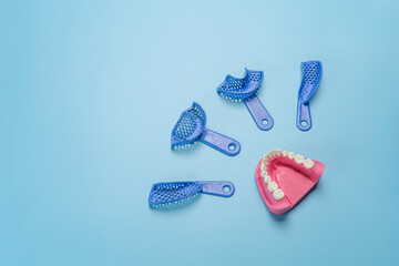 Set of dental pliant impression trays with a layout of the human jaw.