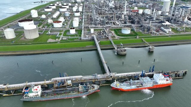 Rotterdam. Aerial Drone view of a Chemical plant and LNG Supertankers Docked in Port Awaiting Offloading and Loading of Fuels and Cargo Petroleum. Tanker Vessel for Chemical or Methane
