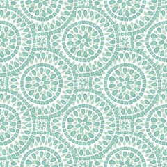 Beautiful seamless pattern featuring circular motifs and delicate leaf designs in soft green tones ideal for fabric or wallpaper applications