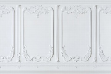 A close-up view of an elegant white wall featuring intricate plaster moldings and decorative panels. The design showcases classic architectural details, perfect for a sophisticated interior.