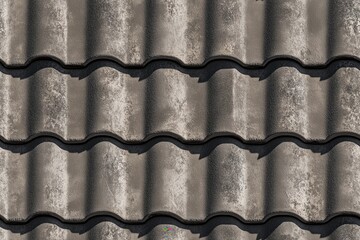 Seamless textured gray roof tiles arranged in a wavy pattern, showcasing the surface details and shadows.