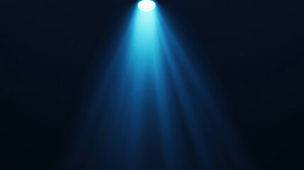 Blue spotlight shining down on a black background