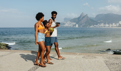Happy family enjoying summertime at Ipanema Beach promenade