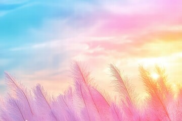 Obraz premium Serene and Vibrant Sunrise Over Soft Pink and Blue Clouds with Feather-Like Grass in the Foreground Capturing Natural Beauty