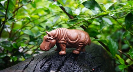 hippo toy, children's toy, brown hippo animal in the photo on wood, looks real and unique