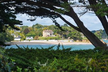 Idyllic beach huts and villa at Port-Manech, Brittany coast.