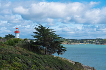 Port-Manech lighthouse on green cliffs overlooking the turquoise sea