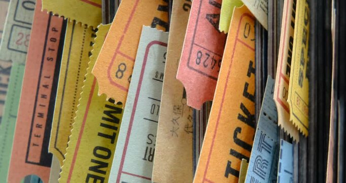 Old tickets stuck between the pages of a rolled-up magazine, close up view