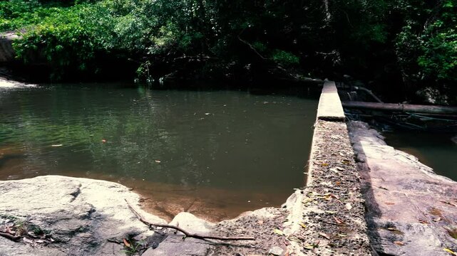 Panoramic view of a small dam of a mountain river in the jungle