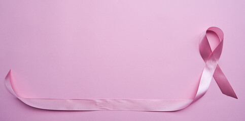 Pink ribbon on color background, top view. Cancer awareness Photo Formats