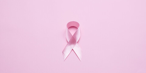 Pink ribbon on color background, top view. Cancer awareness Photo Formats