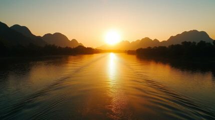 Fototapeta premium Sunrise over the river with mountains and reflection in the water during early morning in a tranquil landscape