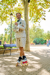 Man in patterned suit posing confidently on rollerblades in a park