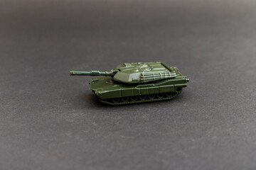 Green military tank model on dark background