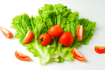 green raw lettuce and slice of tomato pile to make a salad and sandwich isolated on white background