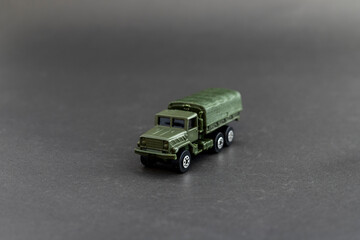 Military truck scale model isolated on black background