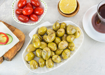 Olives in the breakfast with tomato and lemon