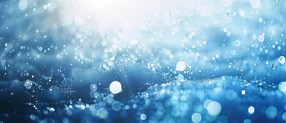 Blurry blue water surface with shimmering bubbles and gentle splashes, illuminated by sunlight, creating a tranquil natural background with ample space for text or design elements.