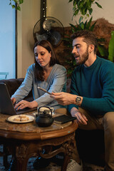 Young adults discussing ideas while planning together in a relaxed workspace