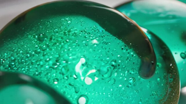 Camera pushes through malachite green alginate spherifying in calcium bath showcasing molecular gastronomy